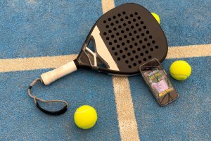 padel tennis racket and smartphone with betting